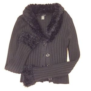 Black sweater with faux fur on collar and wrists.